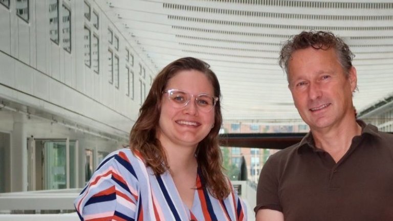 Two researchers showing their latest publication