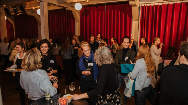 People with drinks at a networking event 